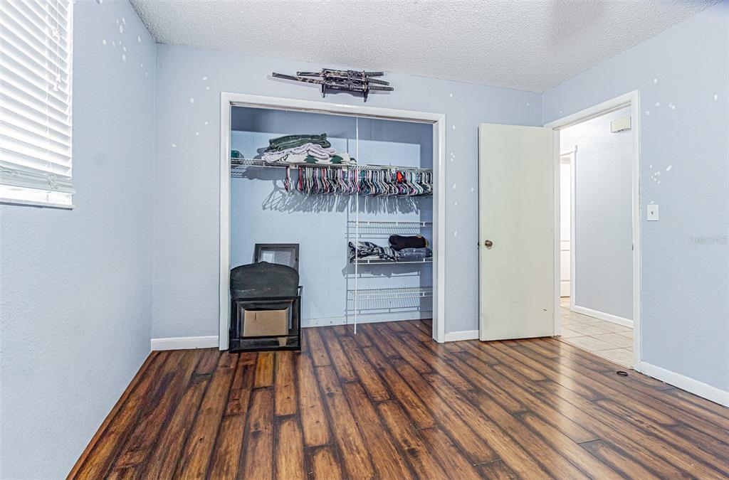 17851 Oxenham Avenue Spring Hill, FL 34610 - Photo 25 of 31 a room with wooden floor and cabinets