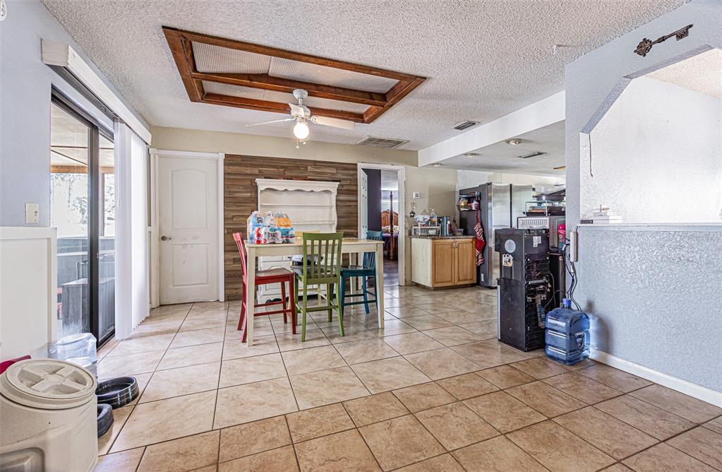 17851 Oxenham Avenue Spring Hill, FL 34610 - Photo 27 of 31 a dining room filled with lots of furniture and a window