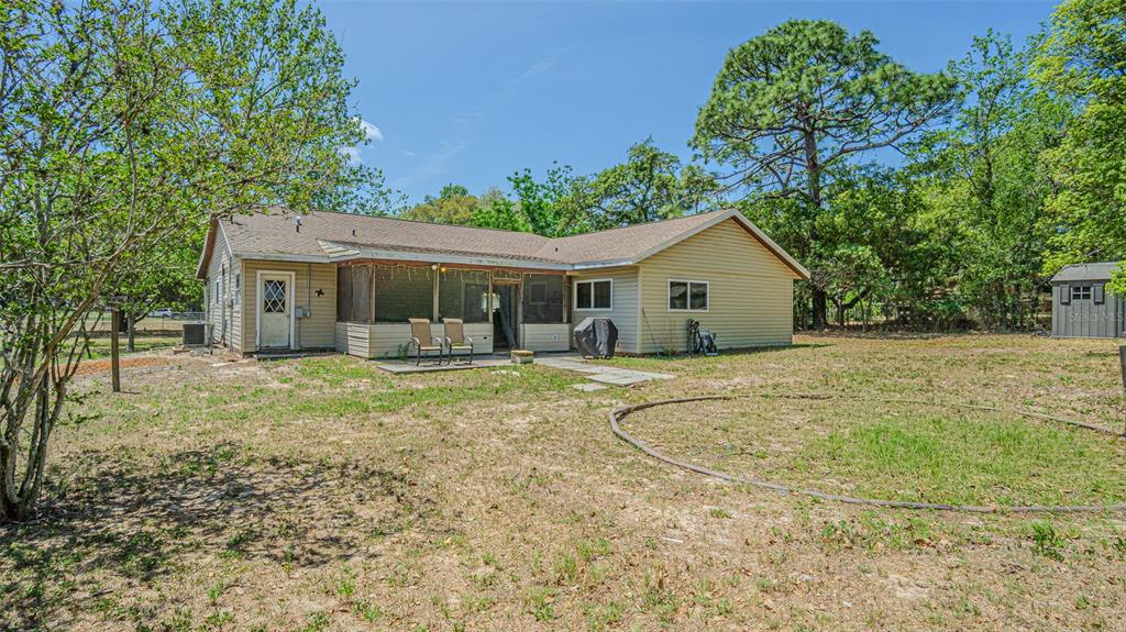 17851 Oxenham Avenue Spring Hill, FL 34610 - Photo 30 of 31 a view of a house with backyard and trees