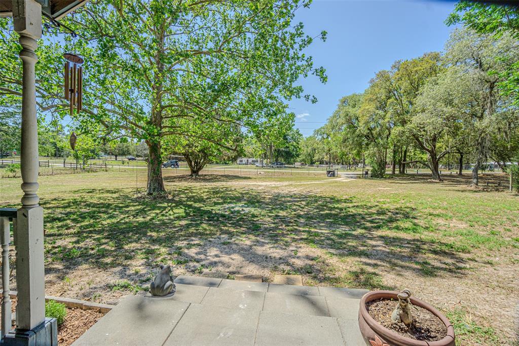 17851 Oxenham Avenue Spring Hill, FL 34610 - Photo 3 of 31 a big yard with lots of green space and trees