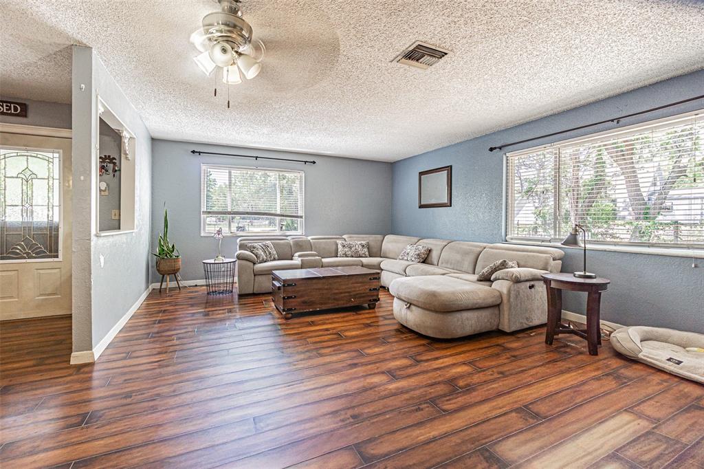17851 Oxenham Avenue Spring Hill, FL 34610 - Photo 8 of 31 a living room with furniture and a large window