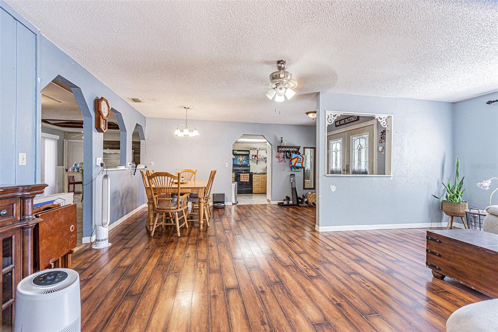 17851 Oxenham Avenue Spring Hill, FL 34610 - Photo 9 of 31 a view of a dining room with furniture a rug and wooden floor
