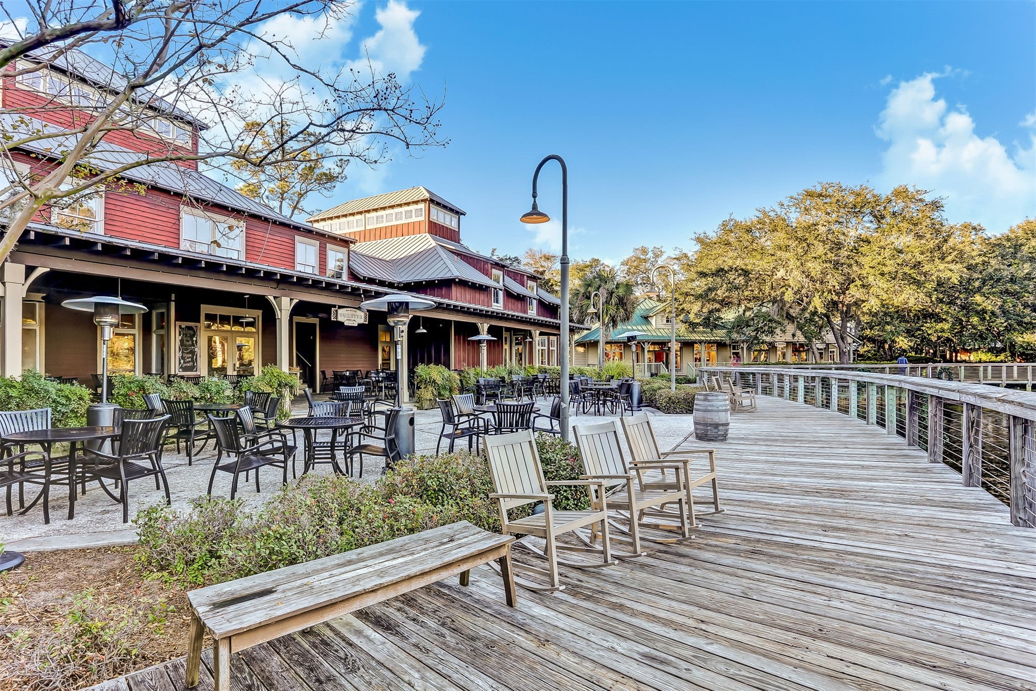 59 Laurel Oak Road Fernandina Beach, FL 32034 - Photo 38 of 54 a view of a patio with table and chairs and potted plants with wooden floor and fence