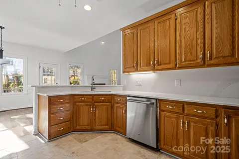 a kitchen with stainless steel appliances granite countertop cabinets and window