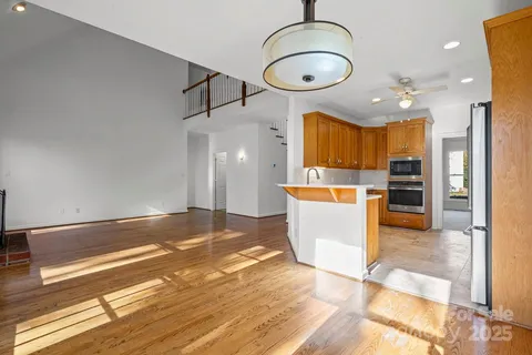 a view of kitchen and hall with wooden floor