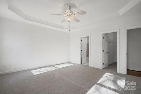 a view of a room with a ceiling fan and a window