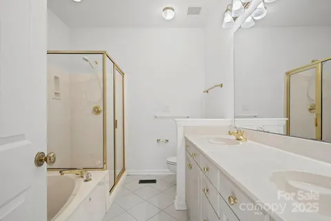a bathroom with a double vanity sink mirror and shower