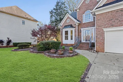 a front view of a house with a yard and outdoor seating