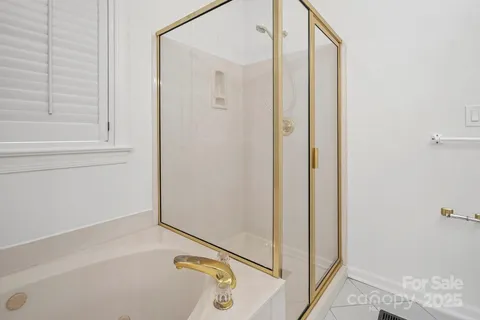 a bathroom with a tub and shower