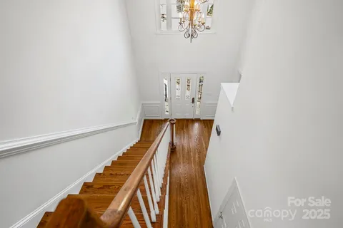 a view of kitchen and hall with wooden floor