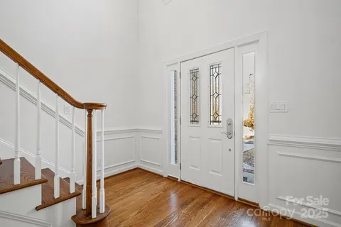 a view of an entryway with wooden floor