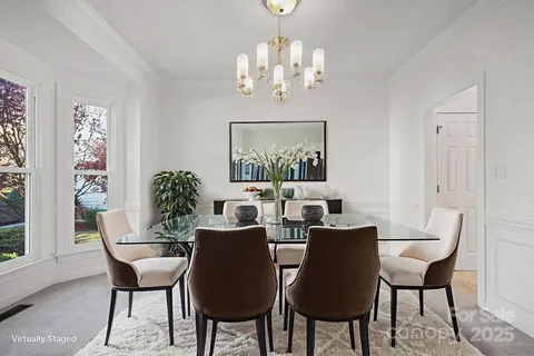 a view of a dining room with furniture and chandelier