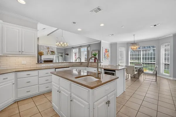 a kitchen with stainless steel appliances granite countertop a sink and a white cabinets