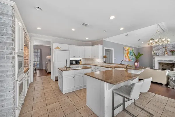 a kitchen with stainless steel appliances granite countertop a sink and a refrigerator