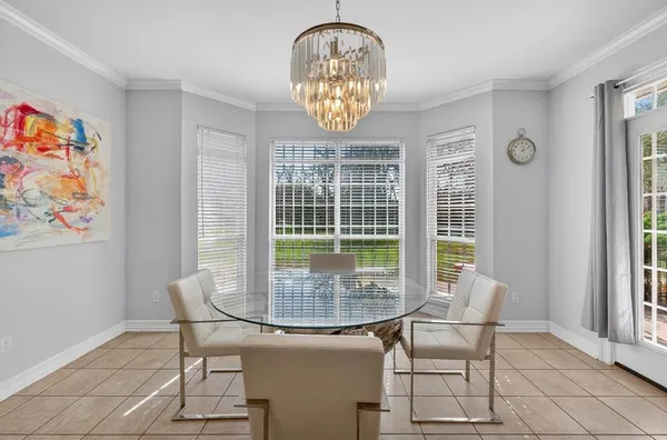 a dining room table with chair and window