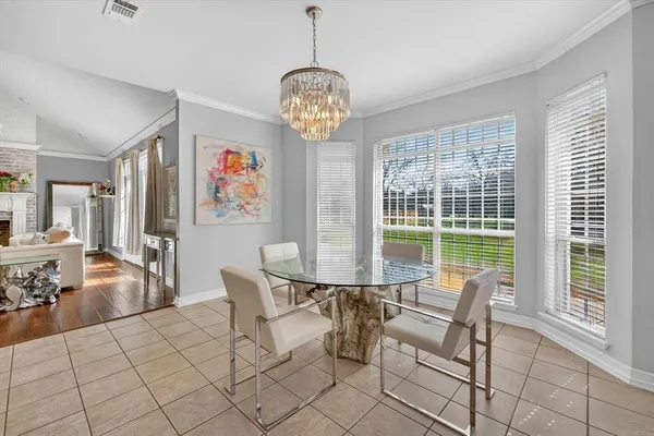 a dining room with furniture a chandelier and window