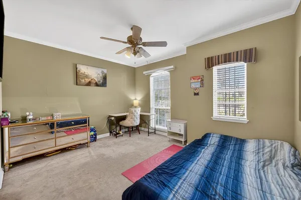 a bedroom with furniture and a window