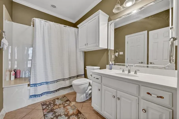 a bathroom with a double vanity sink toilet and a mirror