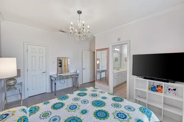 a bedroom with a bed and a flat screen tv in it