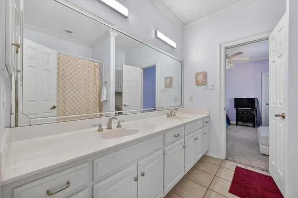 a spacious bathroom with a double vanity sink and mirror