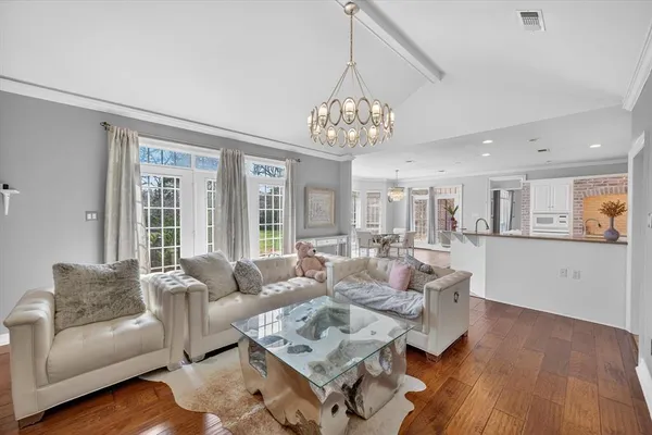 a living room with furniture or kitchen and a chandelier
