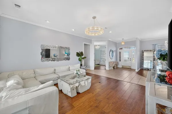 a living room with furniture kitchen view and a dining table