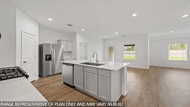 a kitchen with stainless steel appliances granite countertop a refrigerator and a sink