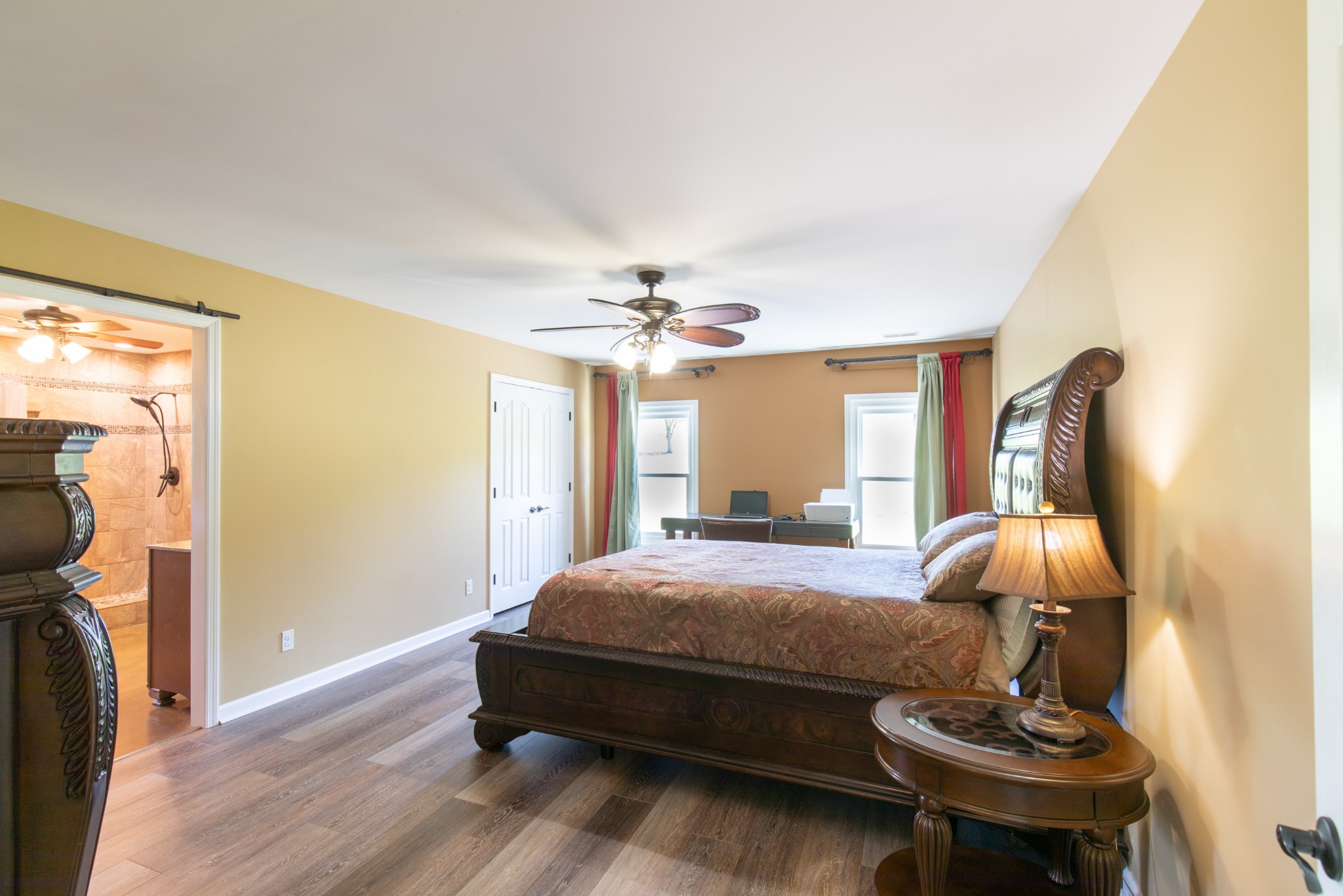6022 Wayman Dunn Road Springfield, TN 37172 - Photo 15 of 35 a bedroom with a bed and a chandelier