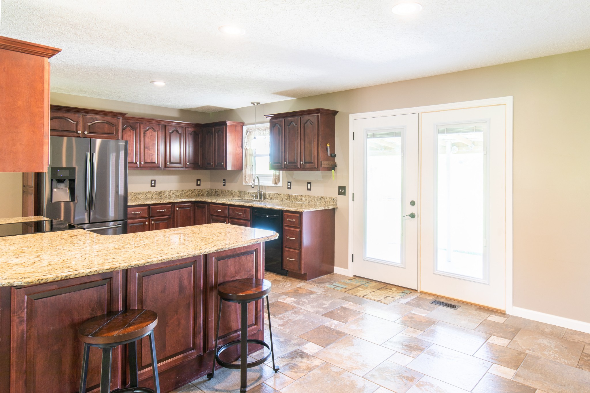6022 Wayman Dunn Road Springfield, TN 37172 - Photo 10 of 35 a kitchen with kitchen island a sink stove and refrigerator