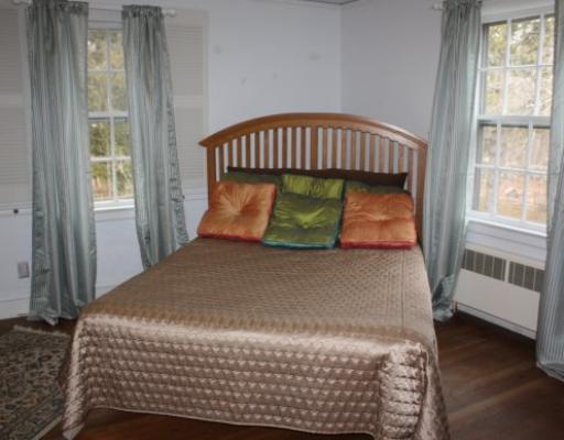 511 Green Bush Road Warwick, RI 02818 - Photo 8 of 12 Bedroom. The Master Bedroom has hardwood floors, a walk in closet and an adjoining bath as well as hardwood floors throughout all of the bedrooms, upstairs hall and stairs. For additional storage enjoy the convenience of pull down stairs for attic storage.