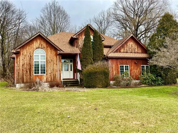 a front view of a house with yard and green space