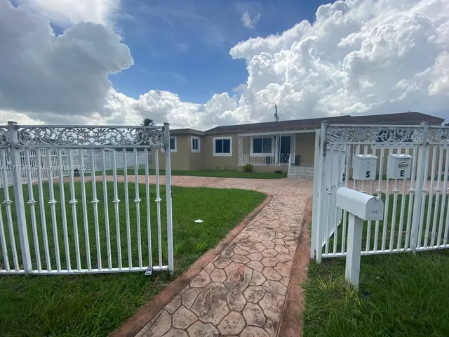 a view of a house with a yard and plants