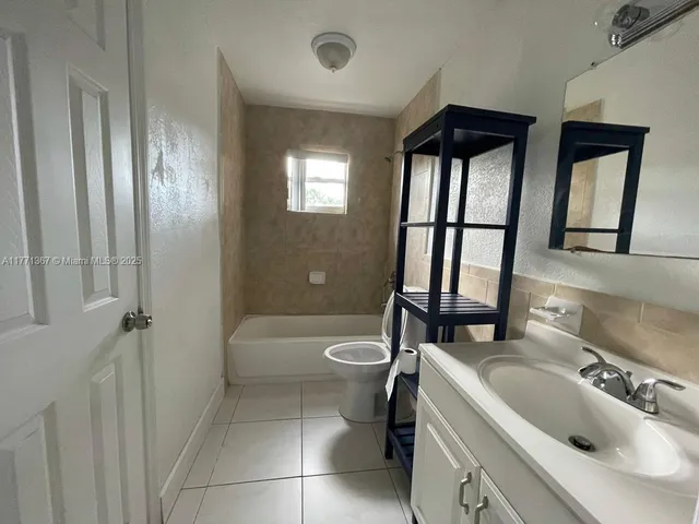 a bathroom with a sink a toilet and a tub
