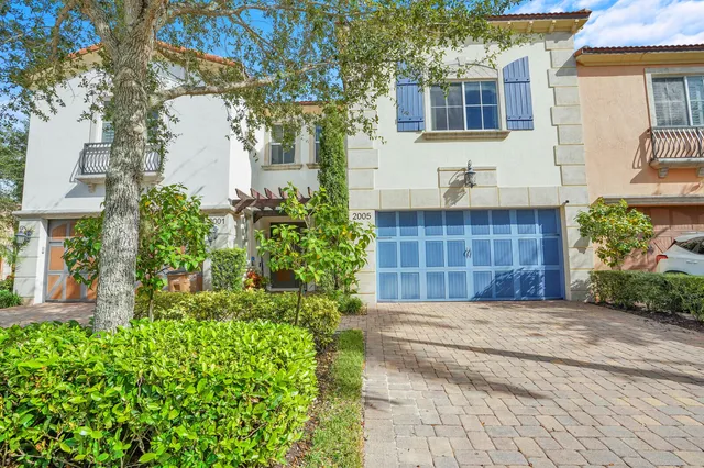 a view of a house with brick walls and flower plants