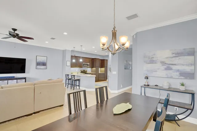 a view of a dining room with furniture and a flat screen tv