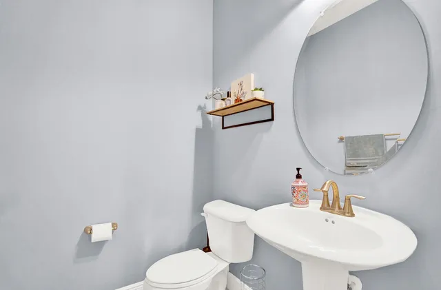 a white toilet sitting next to a bathroom sink