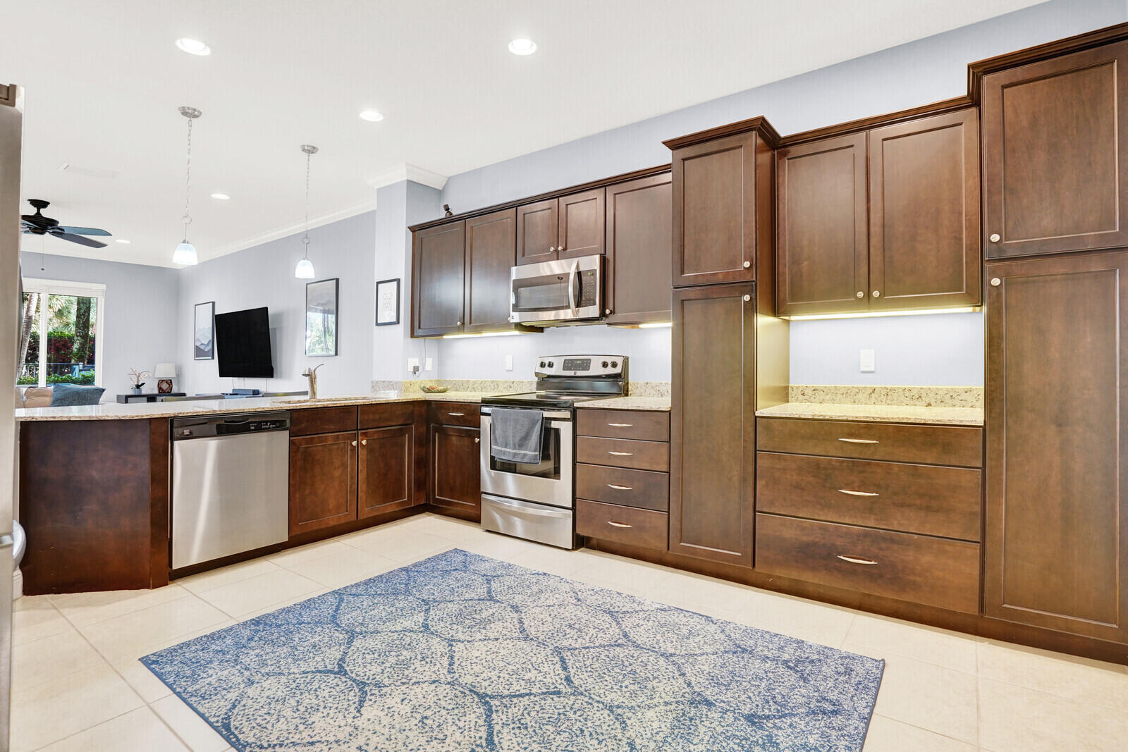 2005 Foxtail View Court West Palm Beach, FL 33411 - Photo 18 of 51 a kitchen with stainless steel appliances kitchen island granite countertop a refrigerator and cabinets