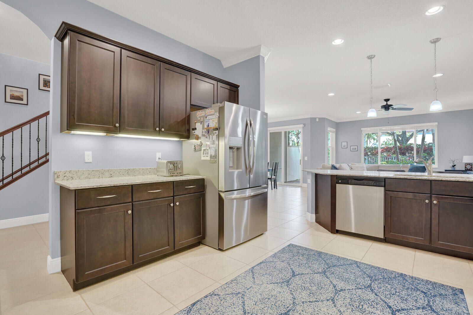 2005 Foxtail View Court West Palm Beach, FL 33411 - Photo 19 of 51 a kitchen with stainless steel appliances granite countertop a refrigerator a sink a stove with wooden cabinets