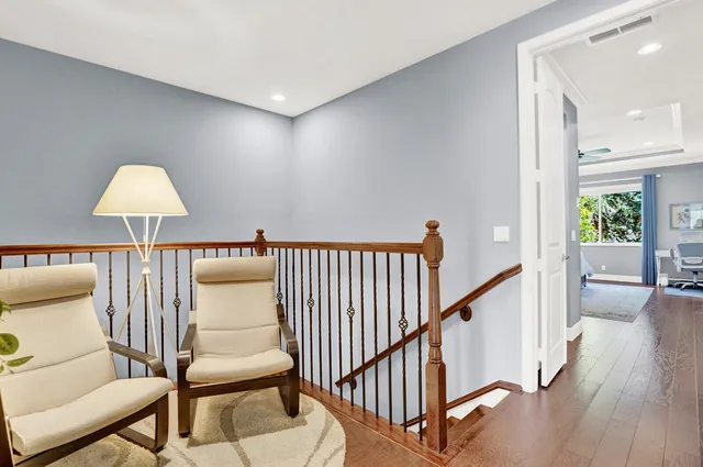 a view of a hallway with a couches and a dining table