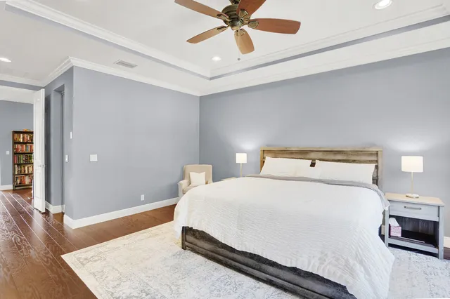 a bedroom with a bed and a chandelier