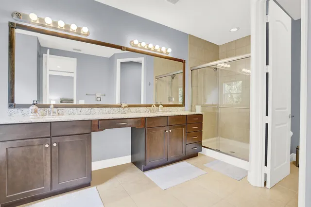 a bathroom with a sink vanity and a mirror