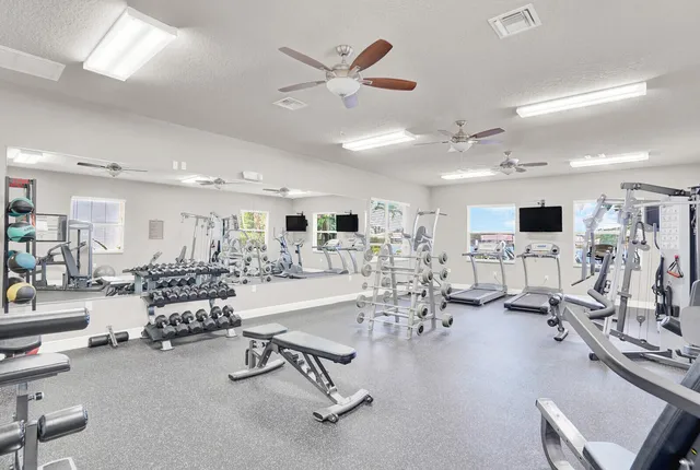 a living room with furniture kitchen view and a large window