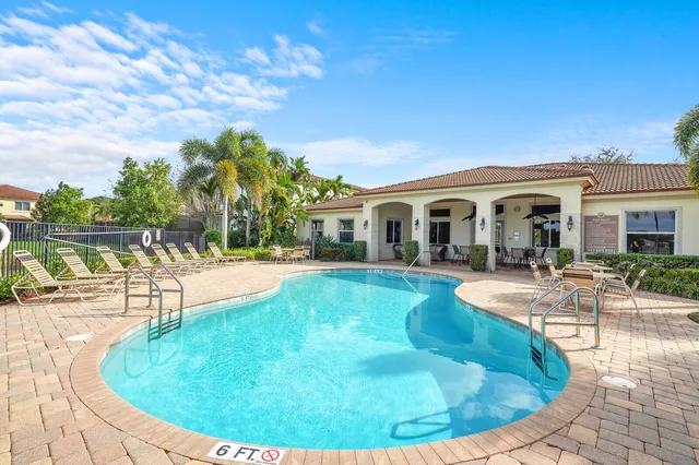 a view of a swimming pool and lounge chairs