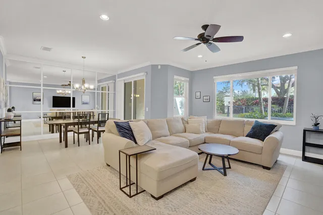 a living room with furniture and view of kitchen
