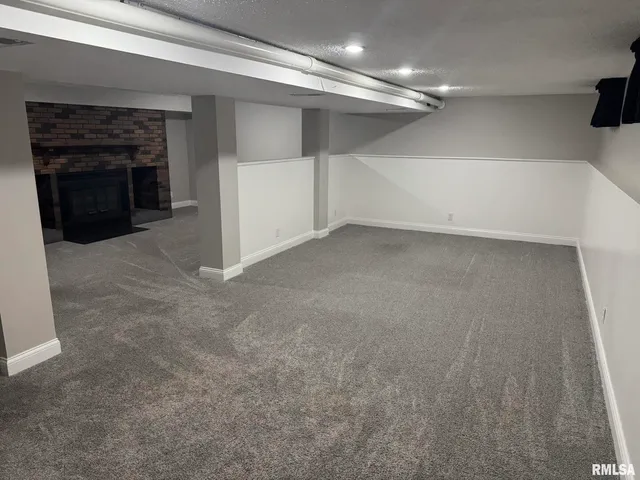 a view of a livingroom with an empty space and a fireplace