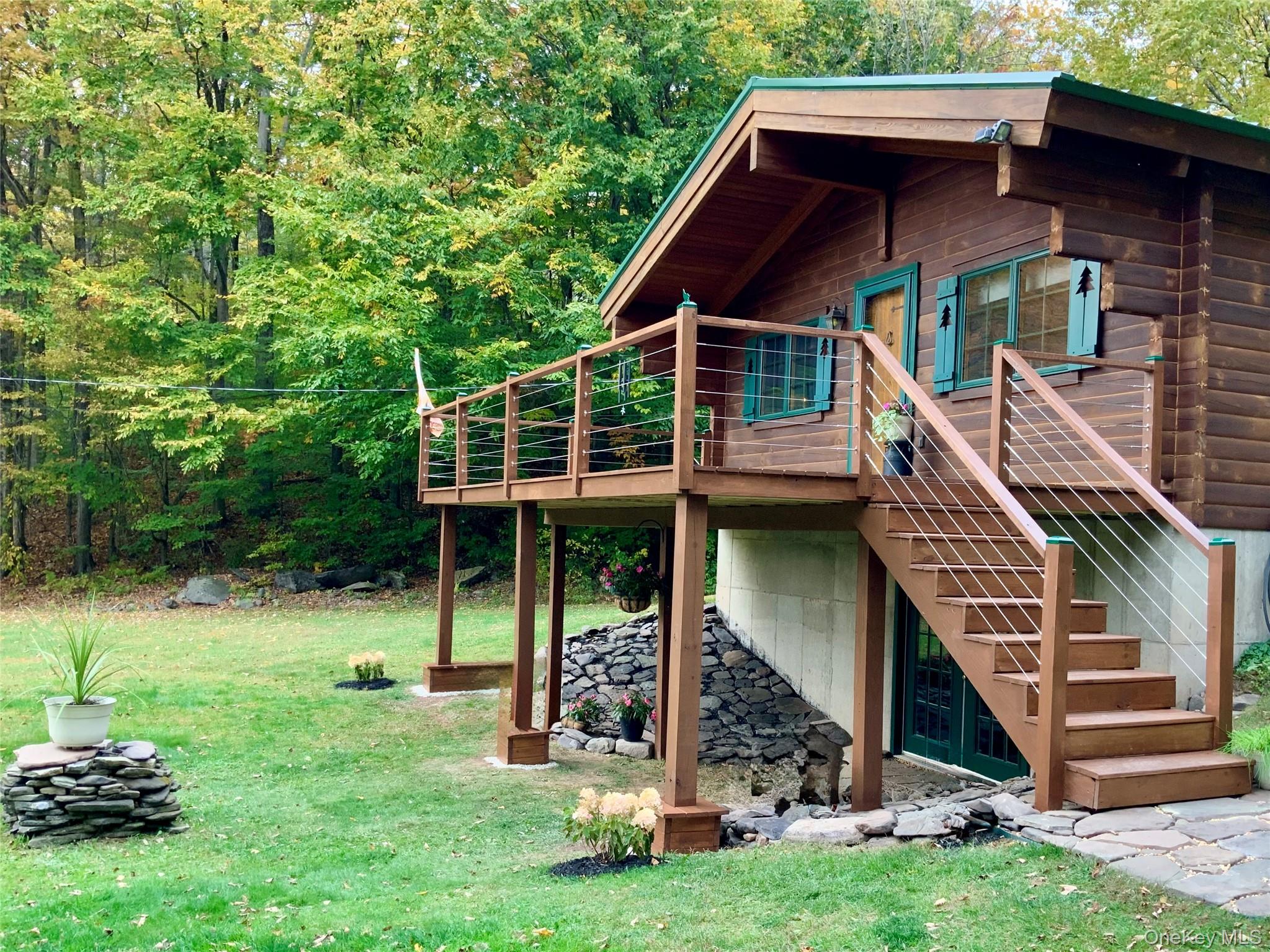 66 Milton Smith Road Long Eddy, NY 12760 - Photo 2 of 25 Elevated front deck overlooking the expansive lawn and woodland backdrop.