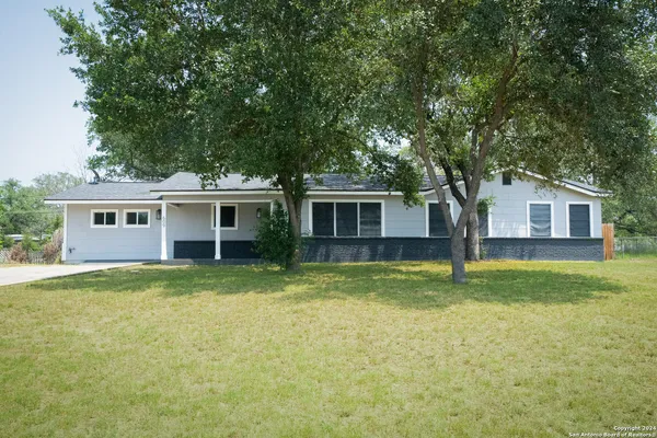 a view of a house with a backyard