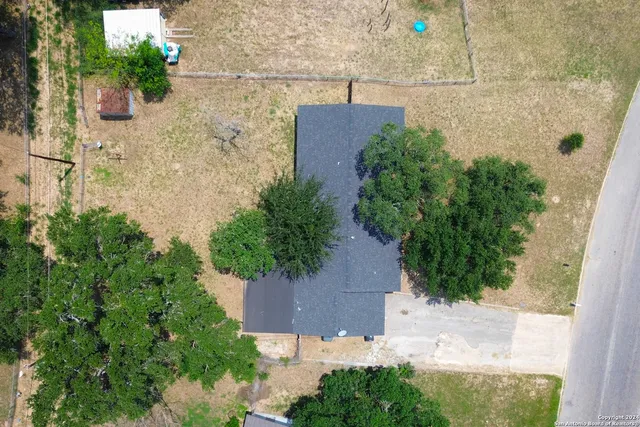 an aerial view of a house with a yard