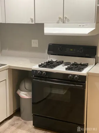 a stove top oven sitting inside of a kitchen