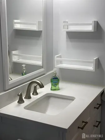 a bathroom with a sink and a window